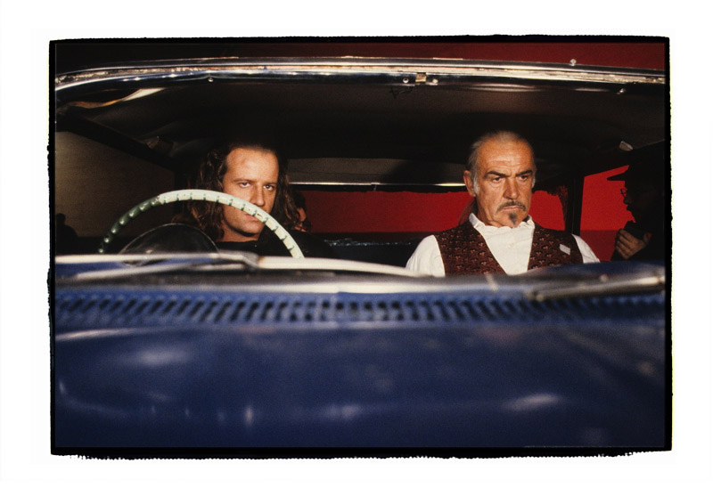 Chris Lambert and Sean Connery are wearing bullet-hit chest squibs and wait to be 'shot' in a scene from Highlander2, 1990. The car is an old chevy Impala action vehicle, of which we had four. The AD on extreme right is Mike Topoozian, who was - and still is, I presume - a splendid chap.
