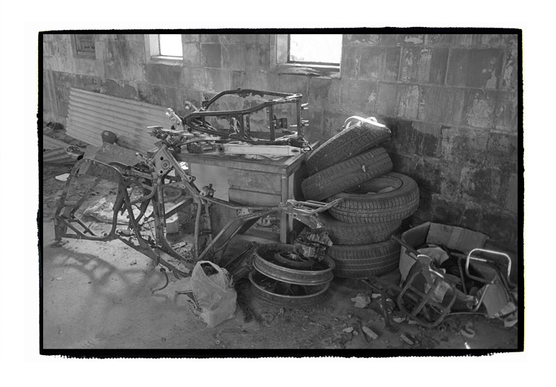 Abandoned motorcycle workshop, still full of old junk.